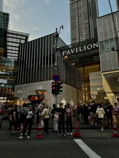 people are standing in front of a tall building