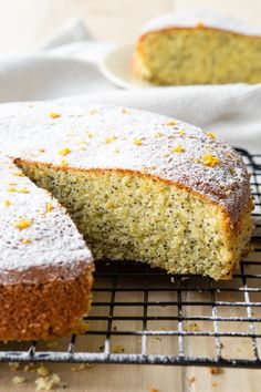 a cake that is sitting on a cooling rack with one slice cut out and the rest half eaten