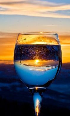 a glass filled with water sitting on top of a table