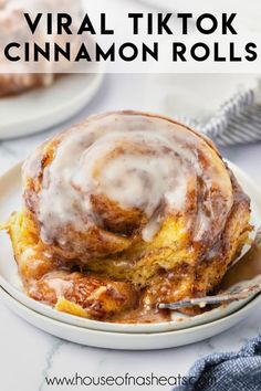 a cinnamon roll on a plate with a fork