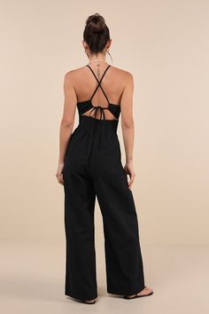 Wherever you go, you'll bring the sunny energy in the Lulus Covetable Vibe Black Linen Lace-Up Backless Wide-Leg Jumpsuit! Crisp, woven linen-blend fabric shapes this effortless jumpsuit that has slender spaghetti straps that lace up the open back, supporting a darted bodice with a plunging V-neckline and a tie detail at the center. Flirty cutout accents the back, atop a fitted waist with comfortable back smocking. Wide legs have side seam pockets, subtle pleating, and end at full-length hems. F Cute Jumpsuits For Women, Beach Jumpsuits And Rompers With Adjustable Straps, Strappy Summer Beachwear Bottoms, Summer Strappy Beachwear Bottoms, Casual Black Jumpsuit With Built-in Bra, Casual Black Jumpsuits And Rompers With Built-in Bra, Chic Beach Jumpsuits And Rompers With Adjustable Straps, Strappy Bottoms With Adjustable Straps For Summer, Casual Backless Beach Bottoms