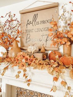 a fireplace mantel decorated with fall leaves and pumpkins