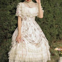 A classic dress and embroidered bonnet for a beautiful Western queen. A gorgeous item that combines pale pink roses and a geometric checkered pattern. The chest and hem are decorated with ruffles that have a strong presence. She is an elegant young lady who is as pretty as a flower. 
 
 
 
 Item 
 
 One Piece 
 Bonnet 
 
 
 Size 
 
 One Piece 
 
 S size 
 
 Length: 103cm 
 Shoulder width: 34.5cm 
 Bust: 88cm 
 Waist: 72cm 
 Sleeve length: 24cm 
 
 M size 
 
 Length: 105cm 
 Shoulder width: 35.5c Princesscore Ruffled Dresses For Garden Party, Princesscore Ruffle Dress For Garden Party, White Doll Collar Dress With Floral Embroidery, Spring Cream Victorian Dress With Ruffles, White Fitted Princesscore Dress, Fitted White Princesscore Dress, Summer Vintage Dress With Ruffles For Tea Party, White Floral Embroidery Dress With Doll Collar, Spring Princesscore Dresses With Ruffles