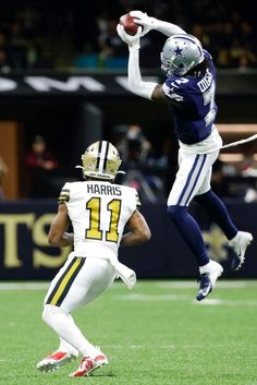 two football players jumping up in the air