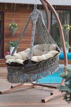 an outdoor swing chair with cushions on it