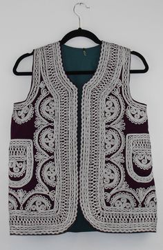 A rare find vintage sleeveless waistcoat from Afghanistan. Size: S/M Bust: 17 Inches Height: 25.5 Inches Note: Worn and minor signs of wear. Folk Style Sleeveless Summer Vest, Sleeveless Folk Style Summer Vest, Traditional Summer Vest, Traditional Sleeveless Summer Vest, Traditional Sleeveless Vest For Spring, Traditional Sleeveless Spring Vest, Folk Style Sleeveless Festival Vest, Vintage Embroidered Sleeveless Vest, Afghan Vest