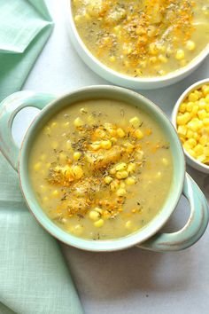 two bowls filled with soup and corn on top of a blue cloth next to a green napkin