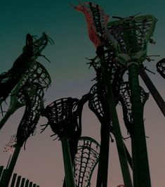 several tall metal sculptures against a blue sky