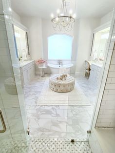 a white bathroom with a tub, sink and toilet in the shower area is shown