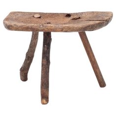 an old wooden stool with two legs and a piece of wood sticking out of it