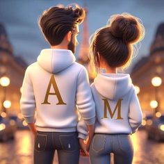 two people wearing matching sweatshirts with the letters a and m on them, standing in front of a street at night