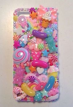 an iphone case with lots of colorful buttons and candys on it's side