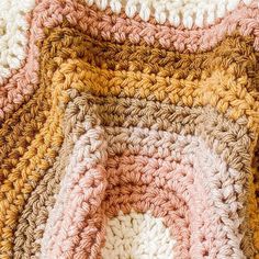 crocheted squares are arranged on top of each other in different colors and sizes