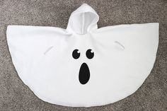 a white bag with black eyes and a ghost face drawn on it's side