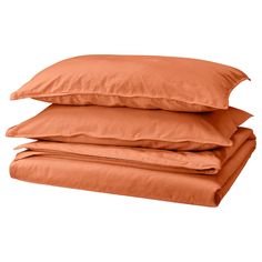 three orange pillows stacked on top of each other