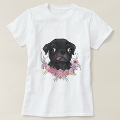 a black dog with flowers on it's chest wearing a white t - shirt