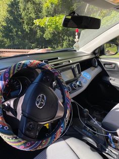 the interior of a car with steering wheel cover