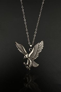 Gaze upon the majesty and strength of the Eagle Men Women Necklace, a unique piece of jewelry that embodies the spirit of these magnificent birds. Handcrafted with an eye for detail, this necklace showcases the beauty and power of both the hawk and the eagle, making it an ideal choice for animal lovers and bird enthusiasts alike. This striking piece is not just a necklace, it's an expression of your love for nature, your appreciation for beauty, and your spirit of freedom. The Eagle Men Women Ne Hawk Eagle, Eagle Necklace, Eagle Design, Bird Necklace, The Eagle, Women Necklace, Pet Necklace, Silver Plated Necklace, Silver Gifts