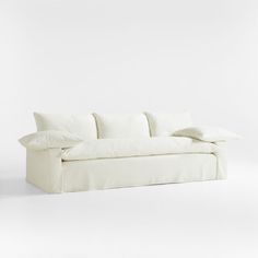 a white couch with pillows on it