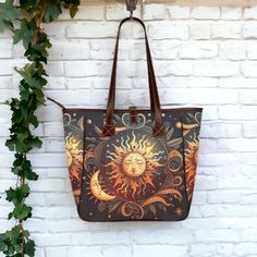 Boho Dark Sun and Moon Celestial Tote. Meet our Classic Tote Bag - the perfect blend of style and practicality! Crafted from high-grade waterproof fabric and vegan leather straps, this oversized 18.11" x 12.99" x 5.71" gem is both durable and water-resistant, which means it's ready for any adventure. With a vibrant two-sided print, it's a head-turner, and the spacious main compartment, along with interior pockets, keeps everything organized. The comfortable portable belt adds convenience, making Gothic Brown Bag For Everyday Use, Gothic Brown Bag, Whimsigoth Aesthetic, Boho Celestial, Dark Sun, Classic Tote Bag, Tote Handbag, Sun And Moon, Shoulder Handbag