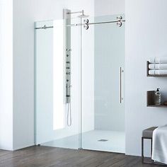 an image of a bathroom setting with glass shower door and towel rack on the wall