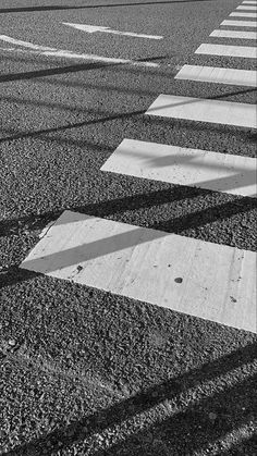 the shadow of a person walking across a crosswalk