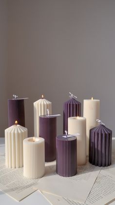 five candles sitting on top of an open book next to each other and one candle in the middle