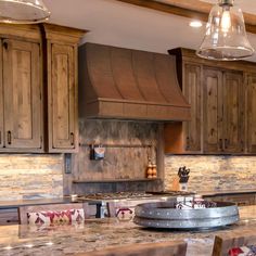 a kitchen with wooden cabinets and marble counter tops