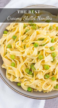 a bowl filled with pasta and peas on top of a table