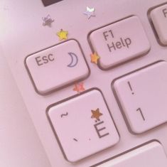 a computer keyboard with stars and moon stickers on it's keys that read esc, fit help