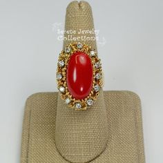 This beautiful oxtail red Coral Ring is set in 14k solid gold and a fancy diamond granulated setting!Ring Size: 7.25Total Weight: 17.17 gramsPrecious Metal: 14k solid goldPrecious stones:-Coral Center Stone: 20mm x 11mm-White Round diamonds: 0.4 ct Formal Red Cluster Ring With Diamond Accents, Heirloom Red Jewelry With Cabochon, Heirloom Red Cabochon Jewelry, Heirloom Red Jewelry With Diamond Accents, Antique Oval Red Diamond Ring, Antique Red Oval Diamond Ring, Red Oval Jewelry With Diamond Accents, Heirloom Red Cluster Ring For Formal Occasions, Heirloom Style Red Cluster Ring For Formal Occasions