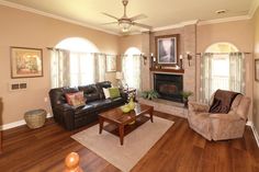 a living room filled with furniture and a fire place in the middle of a room