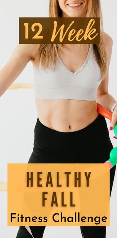 a woman with her arms in the air while holding a pair of exercise equipment and smiling