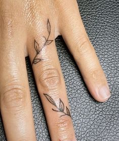 a woman's hand with a small tattoo on it