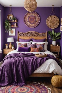 a bedroom with purple walls and white bedding, rugs on the wooden floor