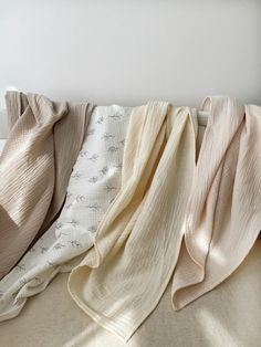 four blankets are lined up on a bed