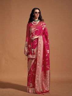 A khadi Georgette Banarasi saree is an exquisite blend of tradition and elegance, crafted in the ancient city of Varanasi. Made from lightweight, sheer georgette fabric, this saree is adorned with intricate brocade or zari work, featuring timeless motifs like florals, paisleys, and Mughal-inspired designs. --------------------------------- S A R E E ● D E T A I L S --------------------------------- ● Fall and Edging : Done ● Tassel : See in Option ● Petticoat : On request Extra Charges ● Drapping Saree (Ready to wear) : On Request Extra Charges ● Blouse : Matching Unstitched Piece (See in option) ● Occasion : Wedding, Party, Festive, Function ● Type: Bollywood ● Includes : 1 Saree, 1 Blouse Piece ● Saree length : 5.5 meter ● Blouse piece : 0.8 meter ● Wash Instruction:- Dry Clean Only Prem Stylish Drapes, Bollywood Designer Sarees, Pink Copper, Stylish Blouse, Georgette Fabric, Traditional Sarees, Varanasi, Pink Saree, Georgette Sarees