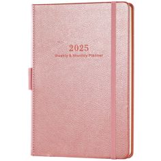 a pink planner book with the words, weekly and month planner on it's cover