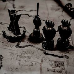 a close up of chess pieces on a map with other items in the foreground