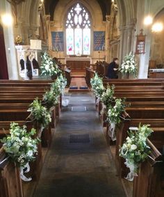 an empty church with pews decorated with flowers