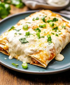 an enchilada is sitting on a blue plate