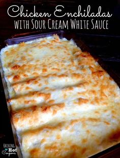 chicken enchiladas with sour cream white sauce in a casserole dish