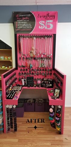 a pink display case filled with lots of jewelry