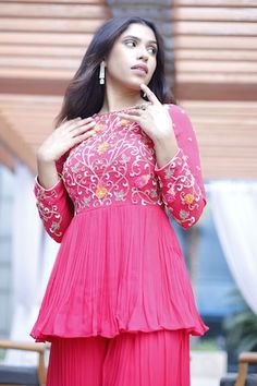 Fuchsia red padded peplum kurta featuring floral thread embroidery on the yoke and sleeves with criss-cross tie-up detailing at the back. Paired with a sharara. - Aza Fashions Red Dresses With Dori Work, Festive Pink Georgette Top, Pink Anarkali Top For Festive Occasions, Festive Pink Anarkali Top, Elegant Semi-stitched Pink Top, Pink Tops For Diwali Reception, Elegant Pink Anarkali Set For Celebration, Pink Top For Diwali Reception, Pink Tops For Reception During Diwali