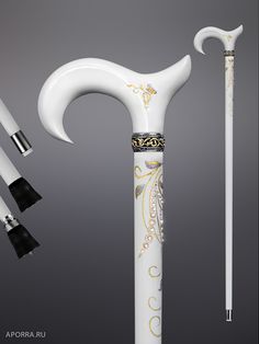 an artistically designed white and gold cane