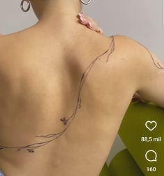 the back of a woman with tattoos on her shoulder