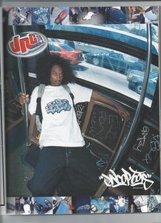 a woman standing in front of a car with graffiti on the wall behind her and holding a skateboard