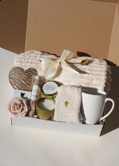 an open box with candles, towels and other items