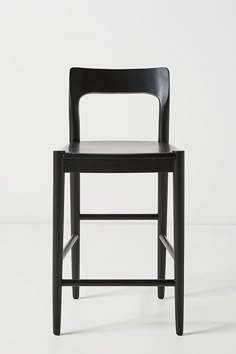 a black chair sitting on top of a white floor