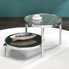 a glass table with two trays on it and a coffee cup in the middle